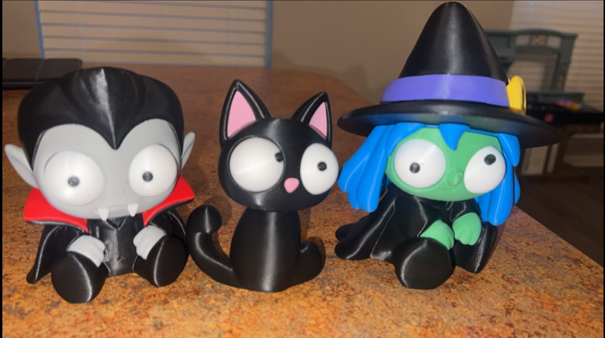 Bravo Forge 3D printed vampire, black cat and blue-haired witch displayed together